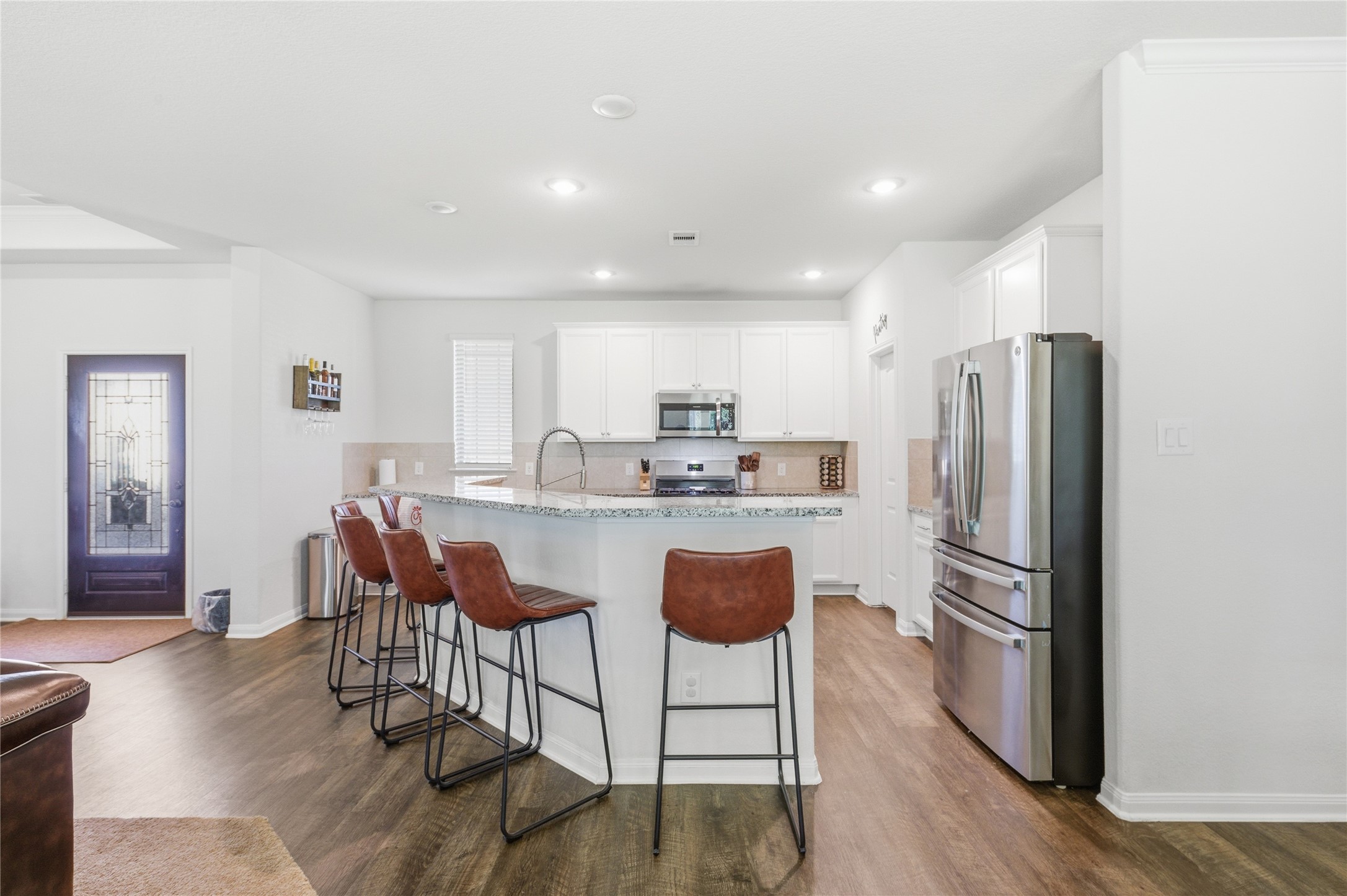 16536 Aransas Conroe, TX 77303 - Photo 13 of 40 a kitchen with stainless steel appliances granite countertop a refrigerator and a stove top oven