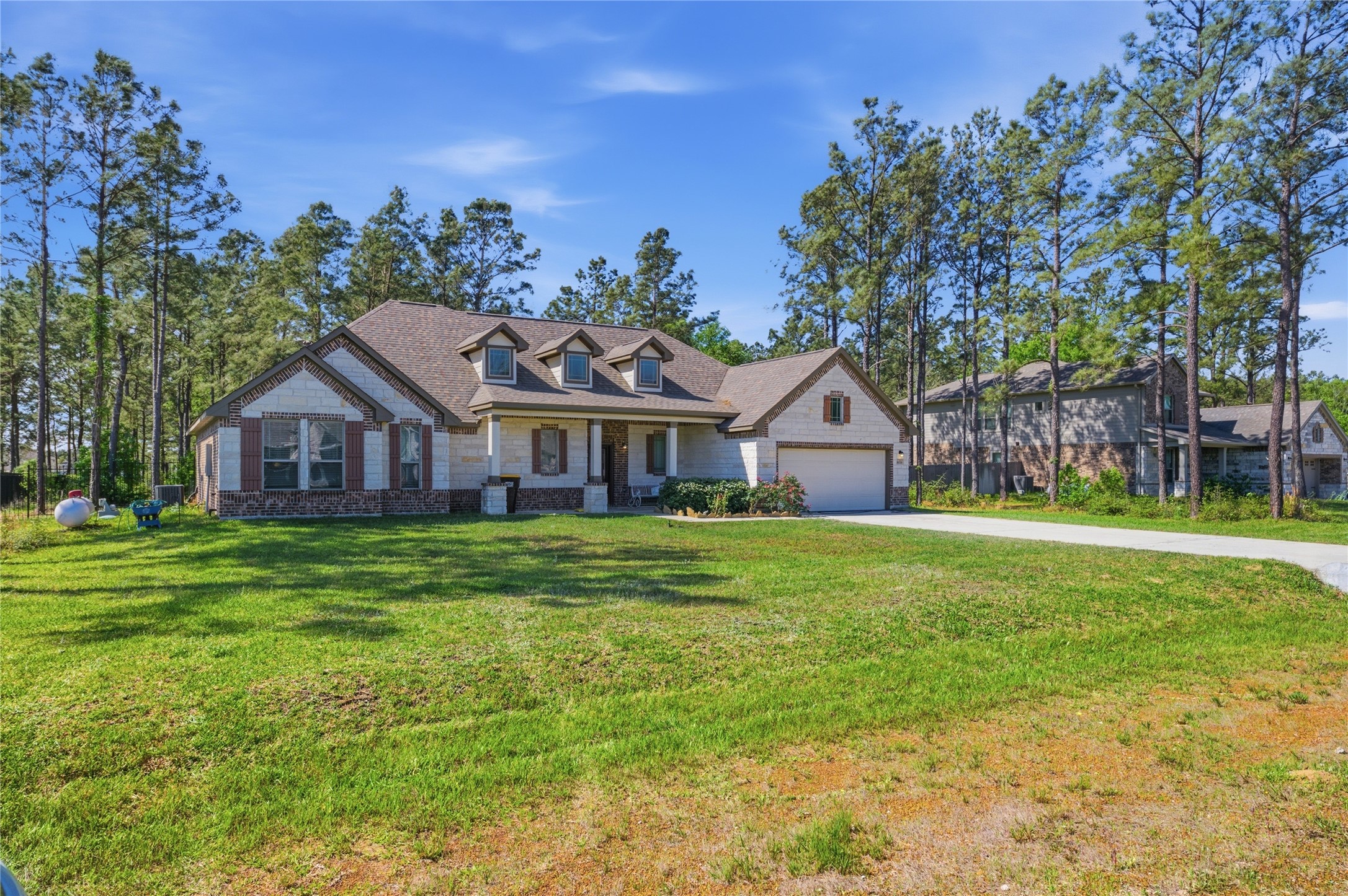 16536 Aransas Conroe, TX 77303 - Photo 2 of 40 a front view of house with yard and green space