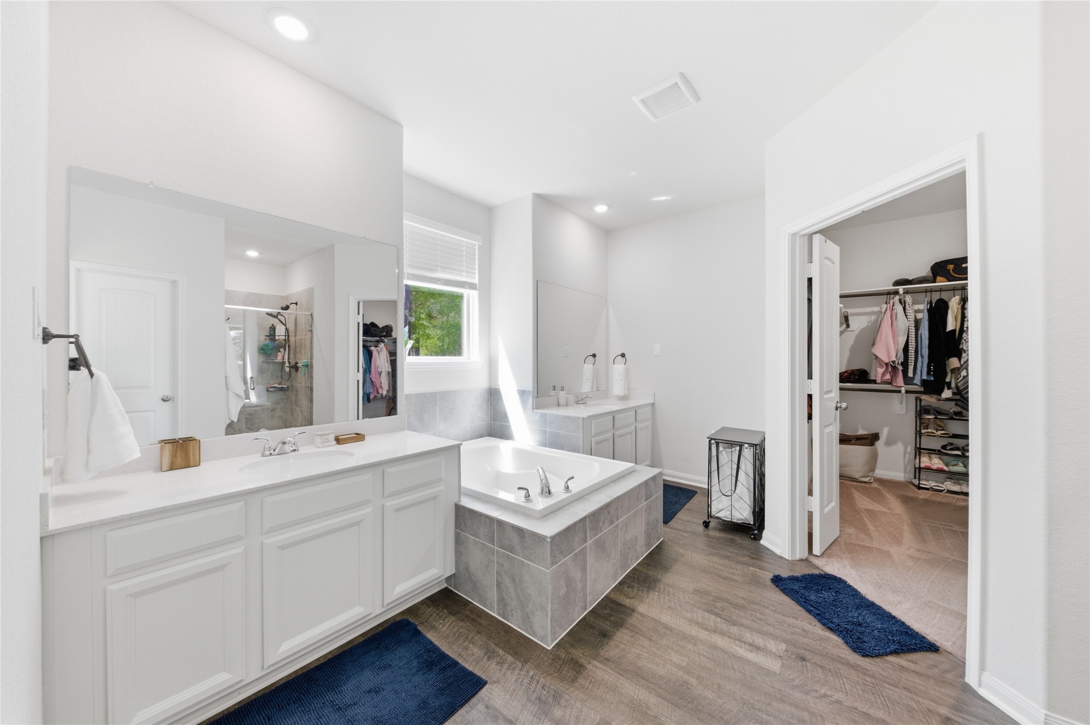 16536 Aransas Conroe, TX 77303 - Photo 21 of 40 a large white bathroom with a double vanity sink a mirror and a bathtub