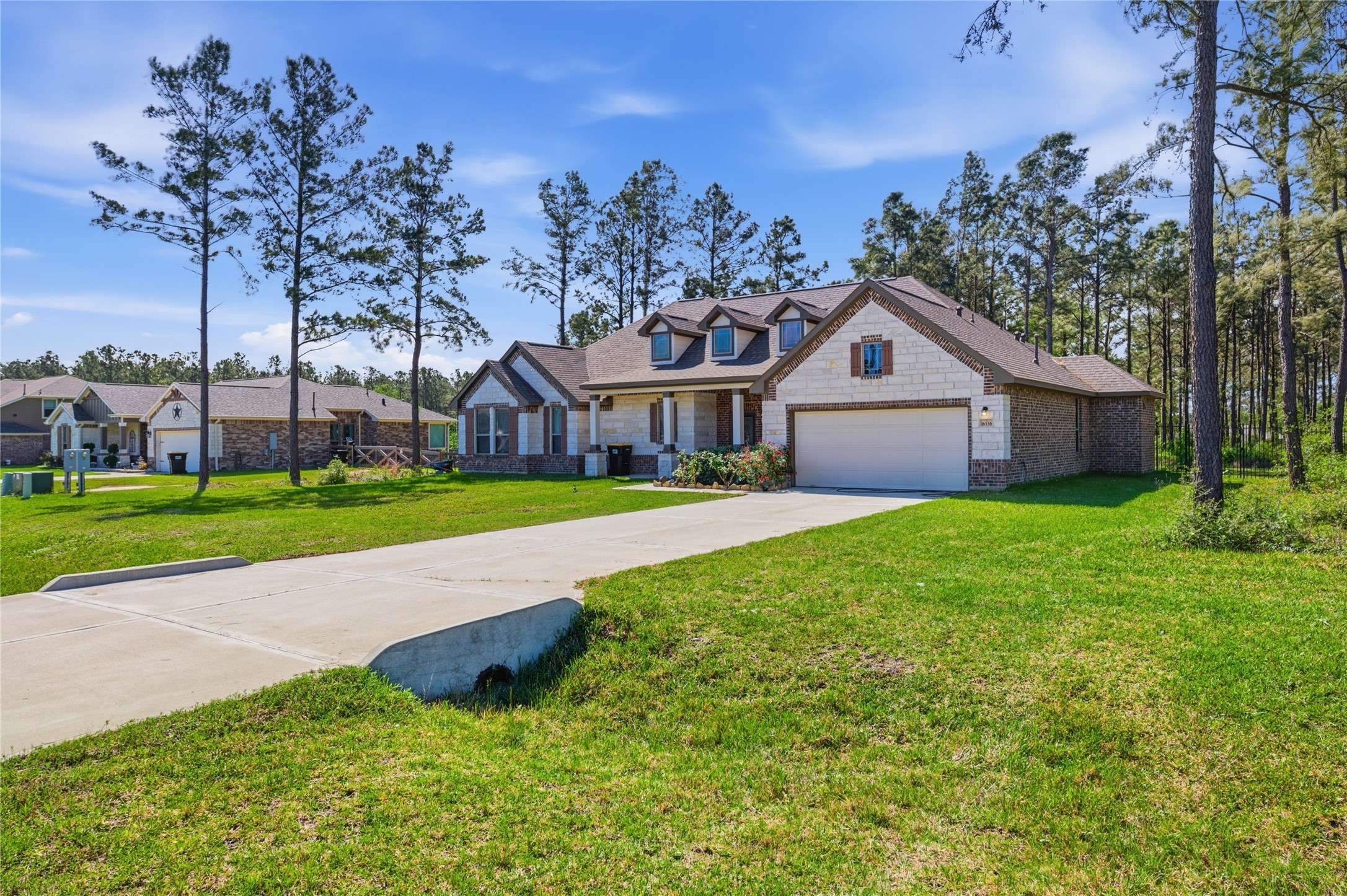 16536 Aransas Conroe, TX 77303 - Photo 3 of 40 a view of a house with a big yard and large trees