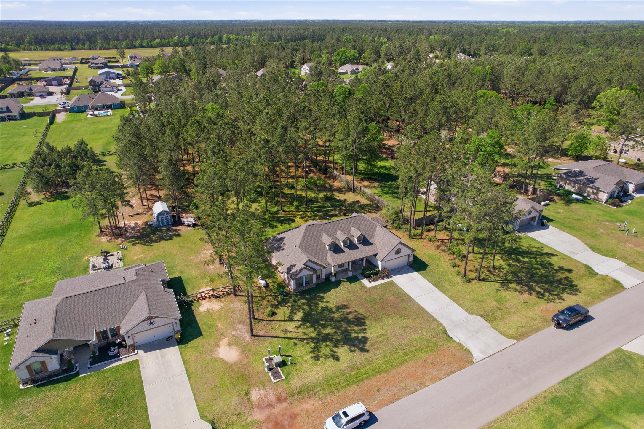 16536 Aransas Conroe, TX 77303 - Photo 38 of 40 an aerial view of a house with a garden and lake view