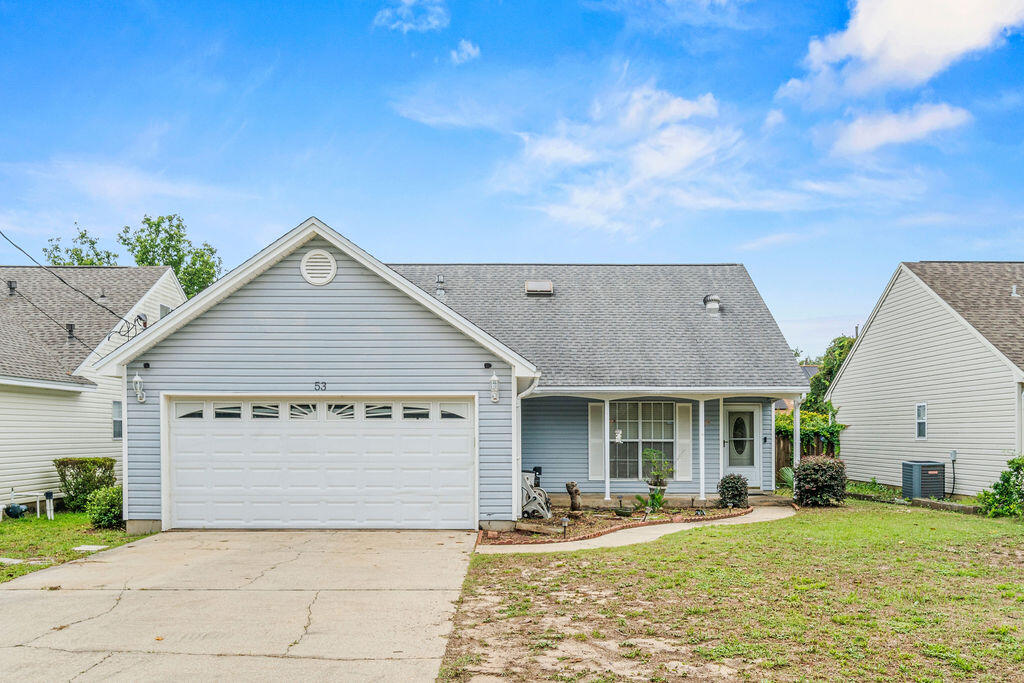 53 4th Street Shalimar, FL 32579 - Photo 1 of 47 a front view of a house with a yard and garage