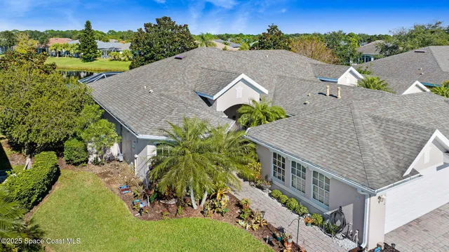 an aerial view of multiple houses with a yard