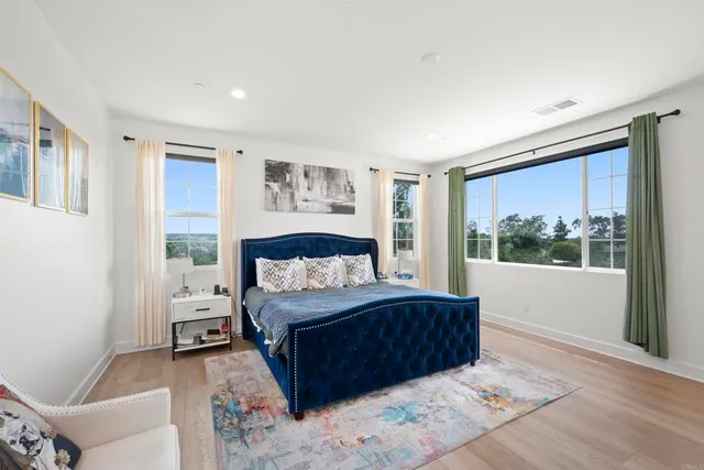 a bedroom with a large bed and a window