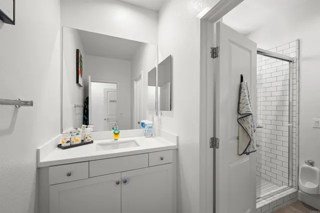 a bathroom with a double vanity sink toilet and shower