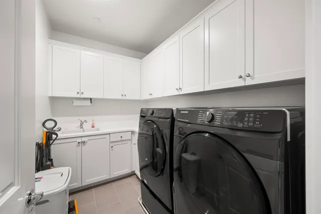 a utility room with sink dryer and washer