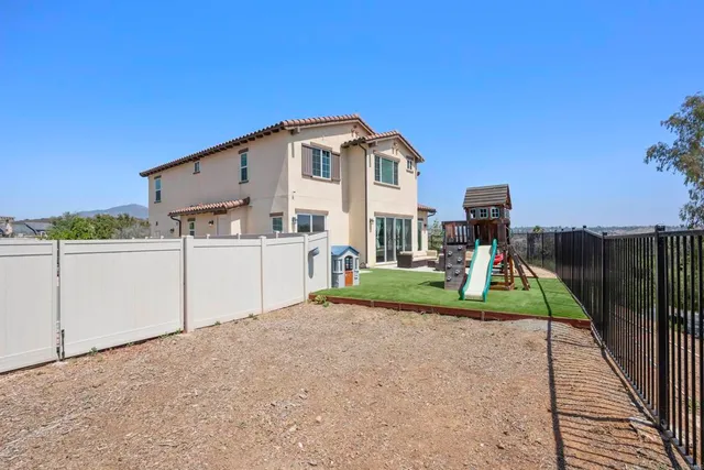 a view of a house with a backyard and a slide