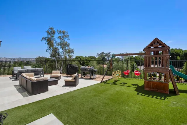 a view of a house with backyard sitting area and garden