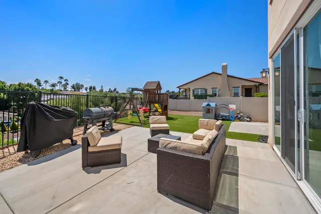 a view of a patio with couches chairs and a fire pit