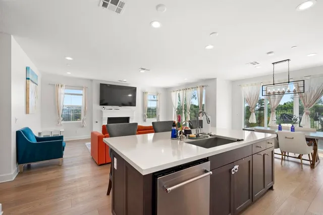 a living room with furniture a flat screen tv and a large window