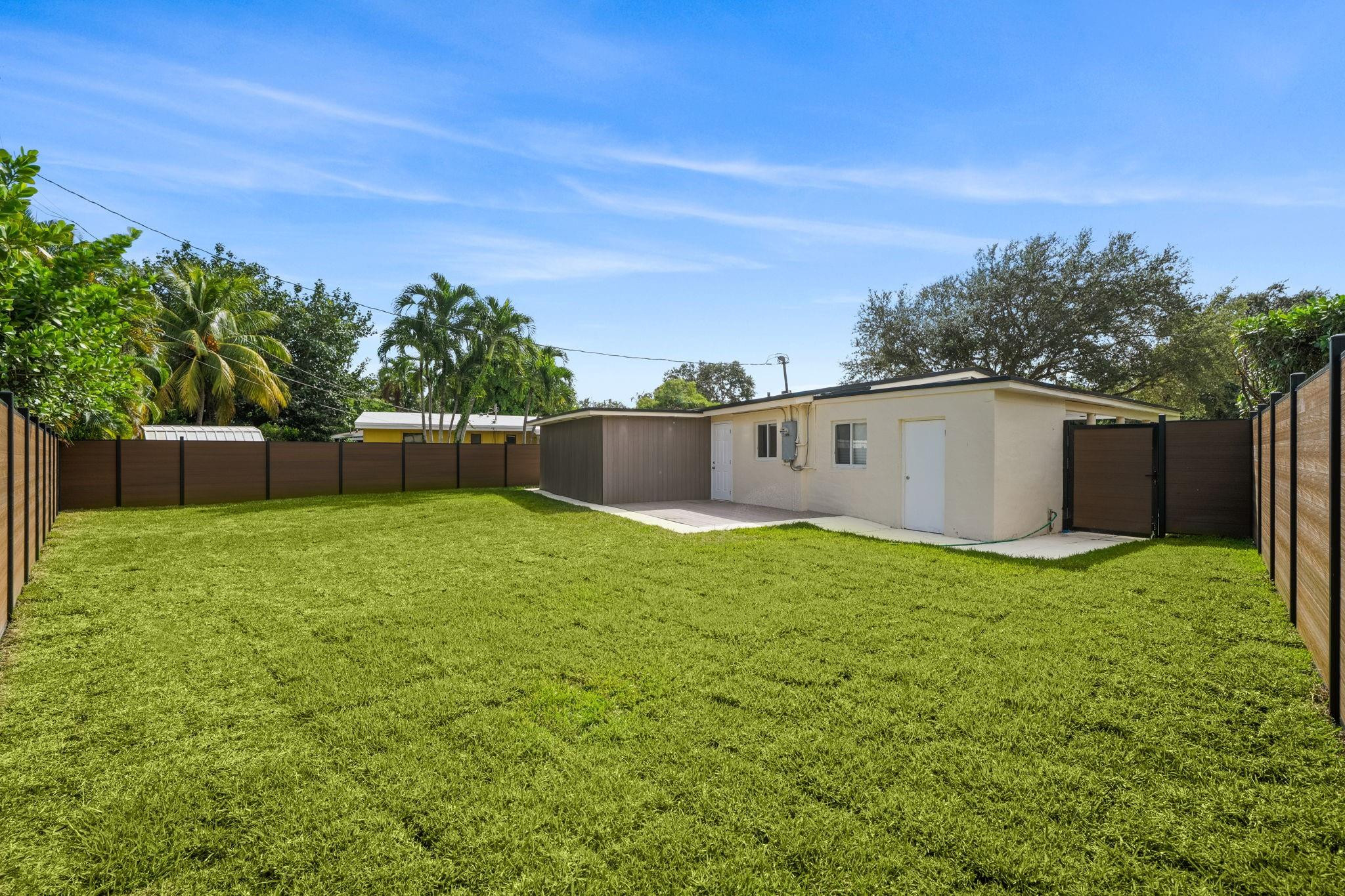 823 Southwest 27th Street Fort Lauderdale, FL 33315 - Photo 3 of 56 a backyard of a house with lots of green space