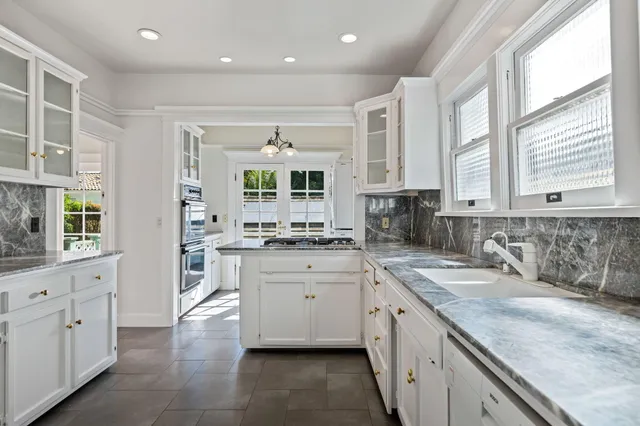 a kitchen with a refrigerator sink and cabinets