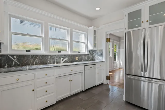 a kitchen with stainless steel appliances granite countertop a stove and a refrigerator