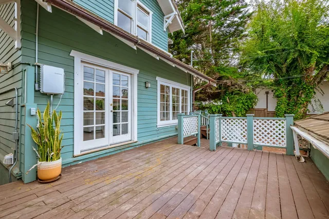 a view of a room with wooden floor and windows