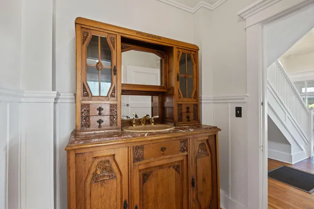 a bathroom with a granite countertop sink a large mirror and shower