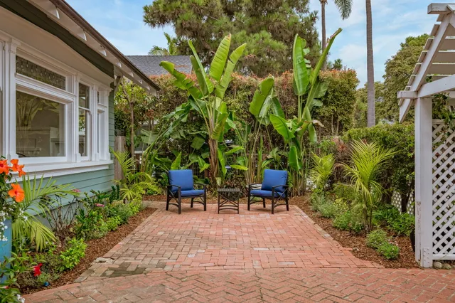 a view of a two chairs in patio of the house