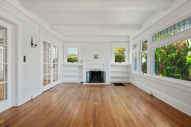 a view of staircase with lots of frames on wall and windows
