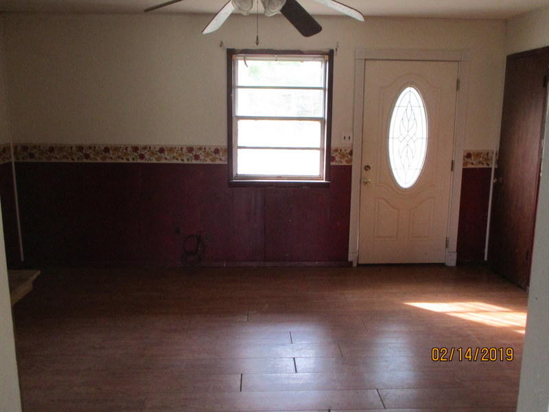 497 Williams Road DeFuniak Springs, FL 32433 - Photo 3 of 20 an empty room with wooden floor and windows