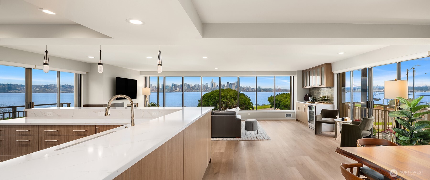 1111 Harbor Avenue Southwest, Unit 200 Seattle, WA 98116 - Photo 2 of 32 a large living room with stainless steel appliances kitchen island granite countertop a sink a counter space and living room view