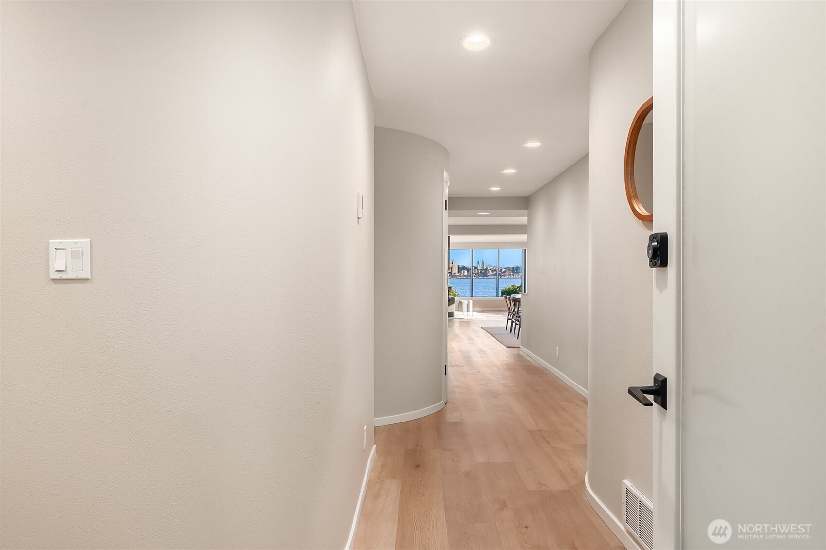 1111 Harbor Avenue Southwest, Unit 200 Seattle, WA 98116 - Photo 30 of 32 a view of a hallway with wooden floor and a bathroom