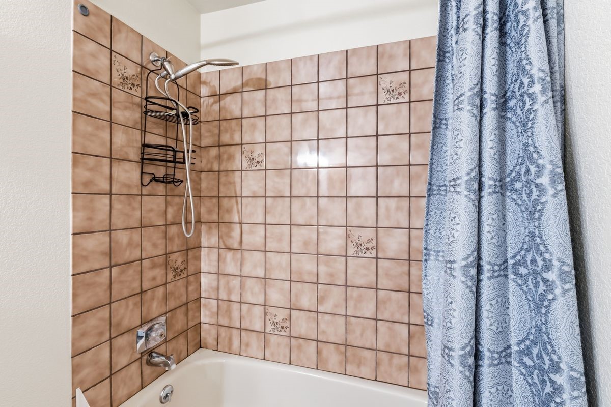 89410 Ryan Gulch Road, Unit 208 Silverthorne, CO 80498 - Photo 15 of 30 a bathroom with a bathtub and shower