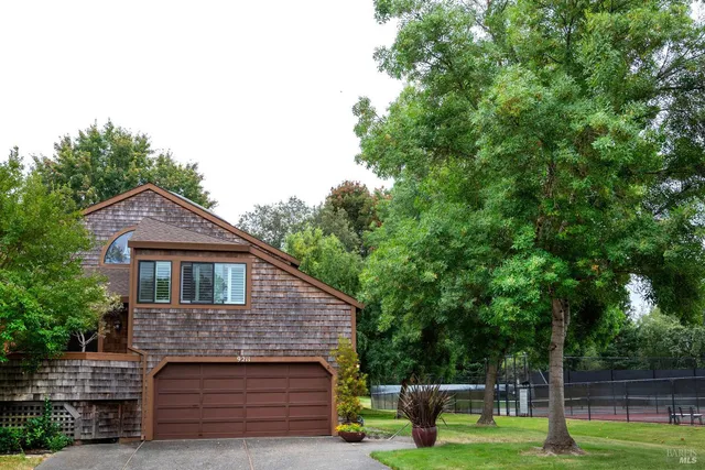 a aerial view of a house with a yard table and chairs