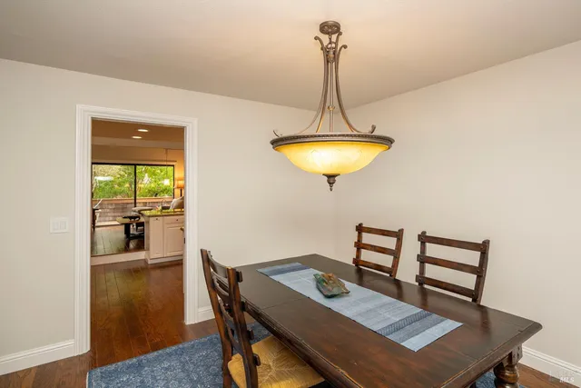 a view of a dining room with a table and chairs