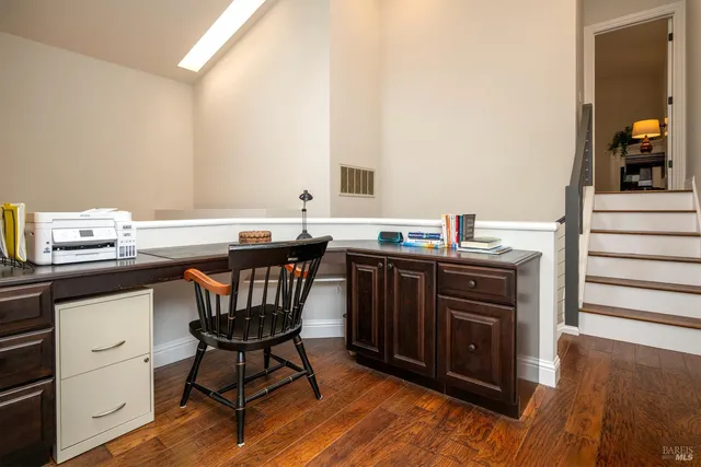 a kitchen with a sink cabinets and wooden floor