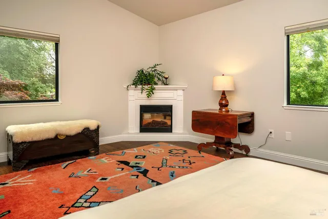 a bedroom with bed and a fireplace