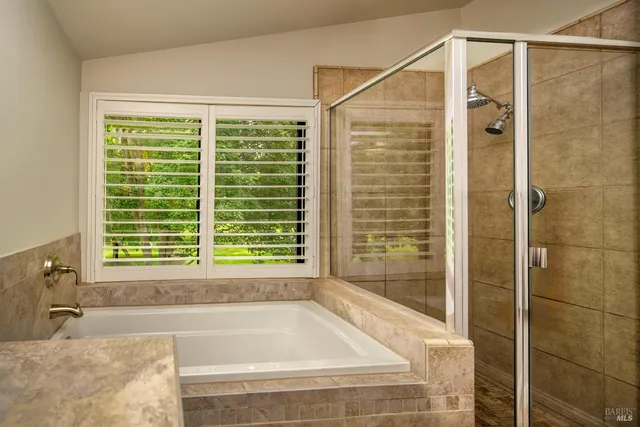 a bathroom with a bathtub and shower