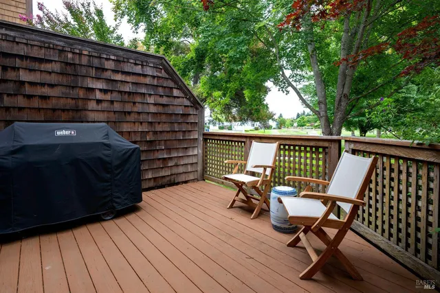 a view of a roof deck with wooden floor and outdoor seating