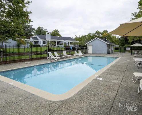 a view of a house with swimming pool and sitting area