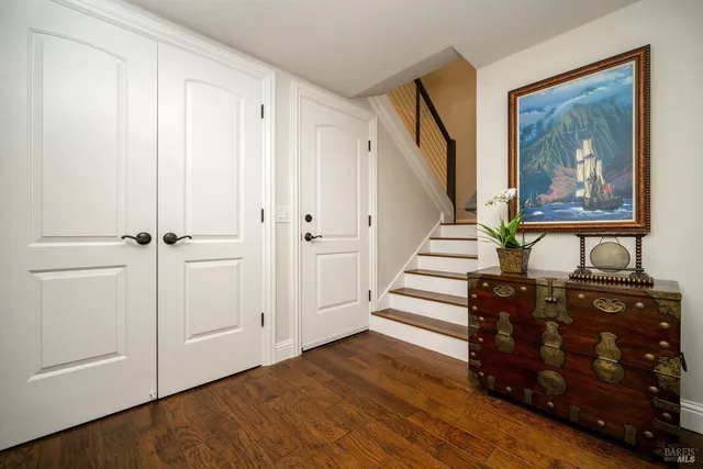 a view of a hallway with entryway wooden floor and front door
