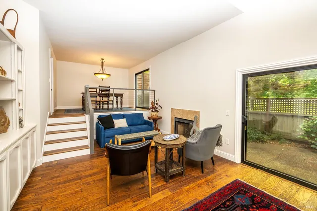 a view of a dining room with furniture a rug and wooden floor