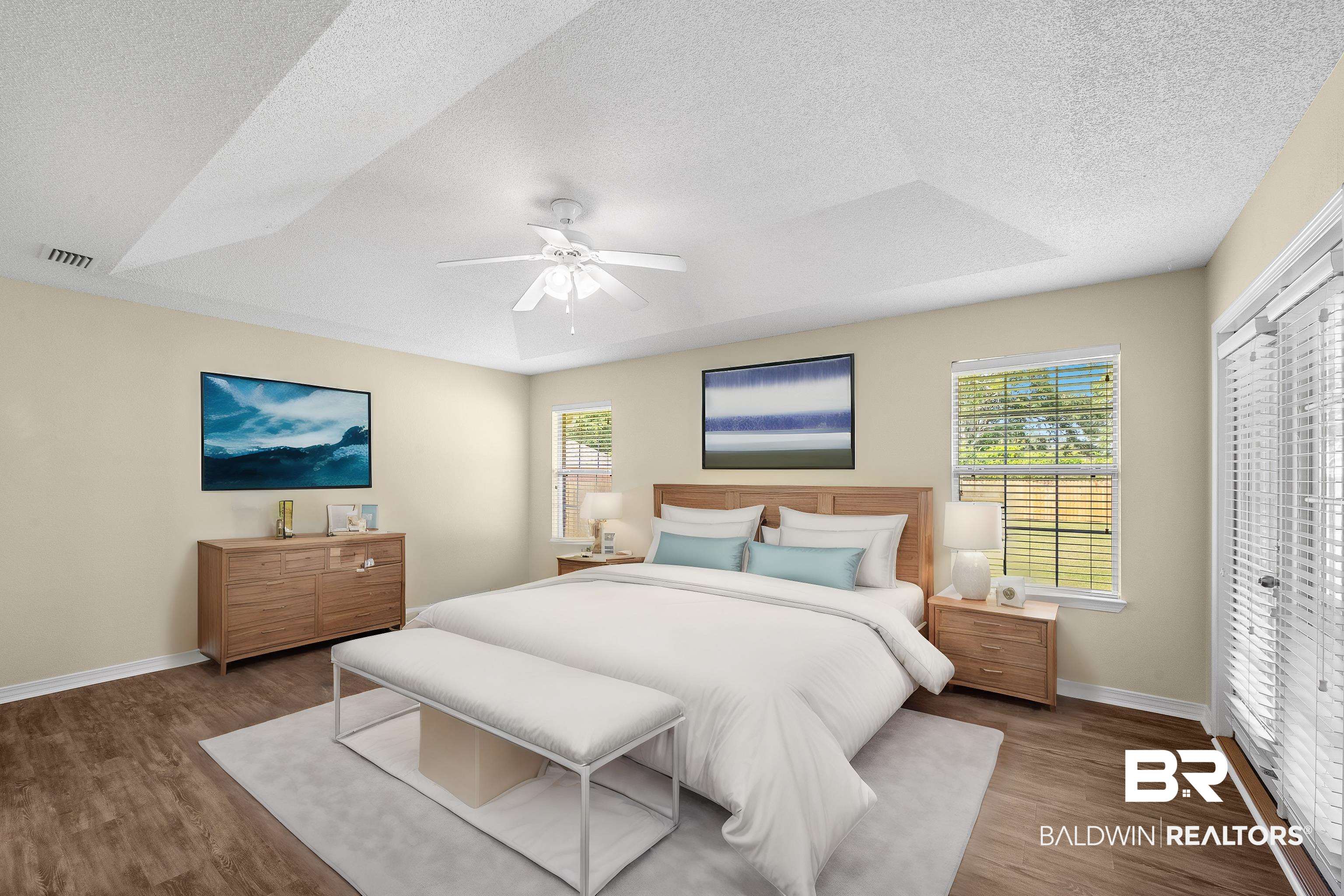 12443 Venice Boulevard Foley, AL 36535 - Photo 40 of 59 Bedroom with a textured ceiling, dark wood-type flooring, ceiling fan, and a raised ceiling