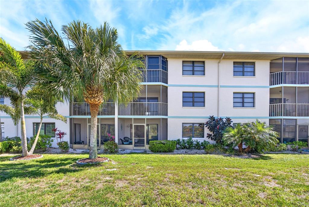 175 Kings Highway, Unit 516 Punta Gorda, FL 33983 - Photo 1 of 37 a front view of a house with a yard