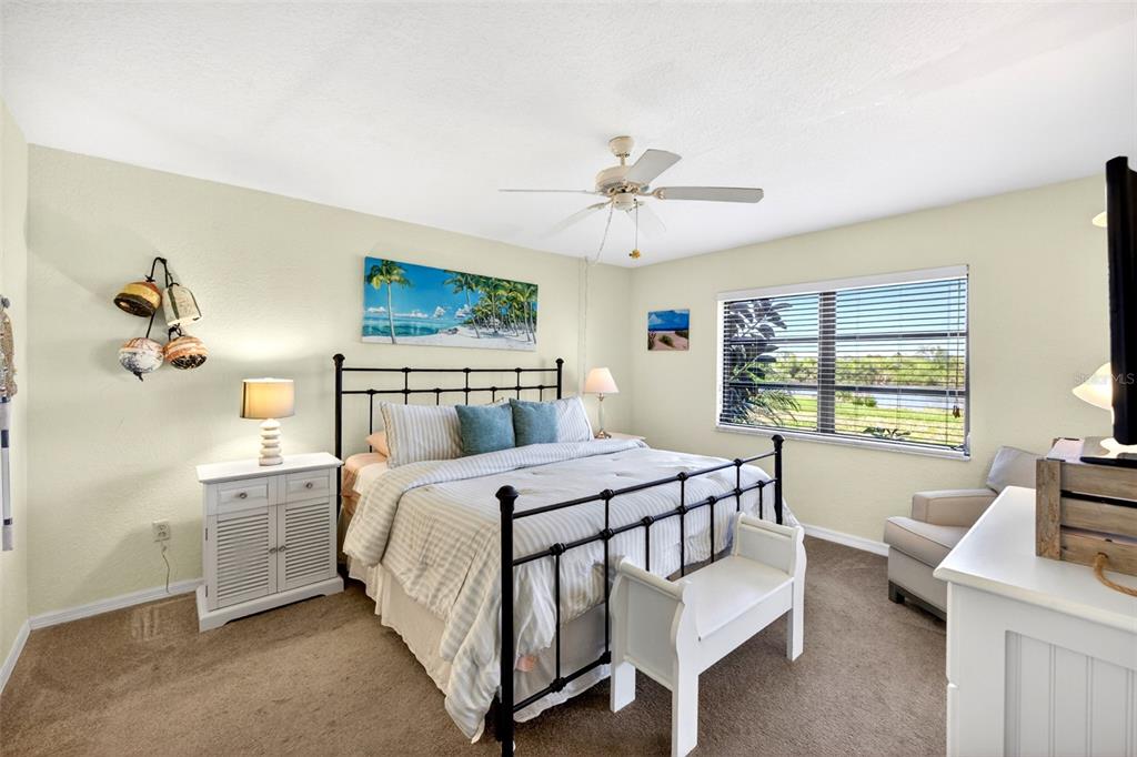 175 Kings Highway, Unit 516 Punta Gorda, FL 33983 - Photo 16 of 37 a bedroom with a large bed and a desk