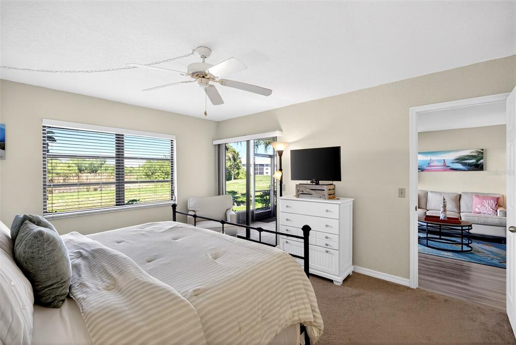175 Kings Highway, Unit 516 Punta Gorda, FL 33983 - Photo 17 of 37 a bedroom with a bed and a flat screen tv