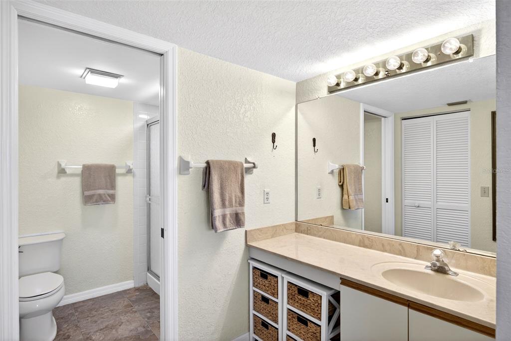 175 Kings Highway, Unit 516 Punta Gorda, FL 33983 - Photo 19 of 37 a bathroom with a granite countertop sink toilet and shower