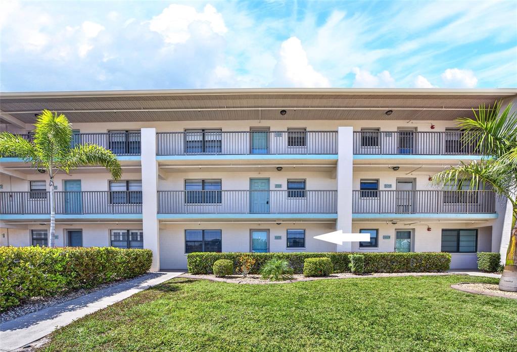 175 Kings Highway, Unit 516 Punta Gorda, FL 33983 - Photo 2 of 37 front view of a building with a yard