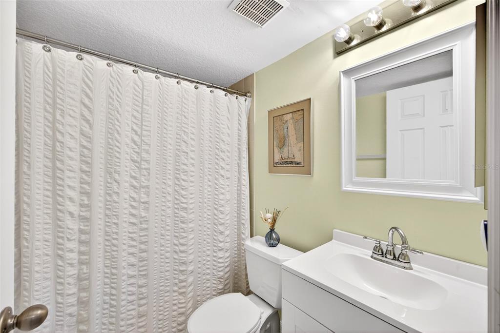 175 Kings Highway, Unit 516 Punta Gorda, FL 33983 - Photo 24 of 37 a bathroom with a sink mirror and a toilet