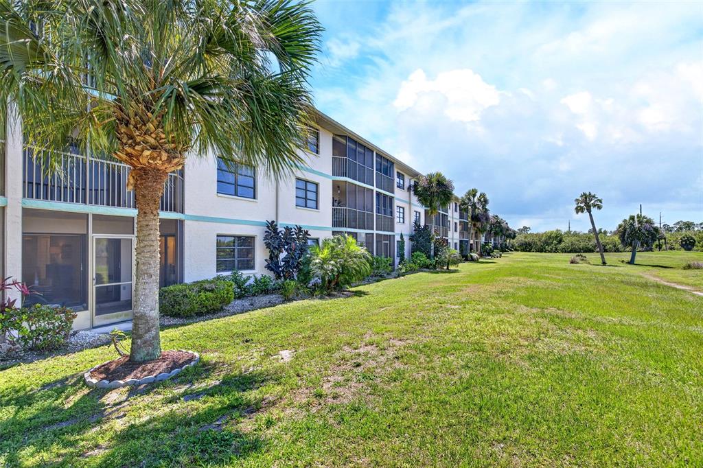 175 Kings Highway, Unit 516 Punta Gorda, FL 33983 - Photo 30 of 37 a view of a house with a yard and potted plants
