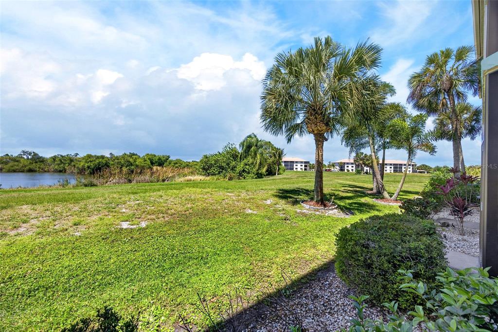 175 Kings Highway, Unit 516 Punta Gorda, FL 33983 - Photo 32 of 37 a view of a garden with a building in the background