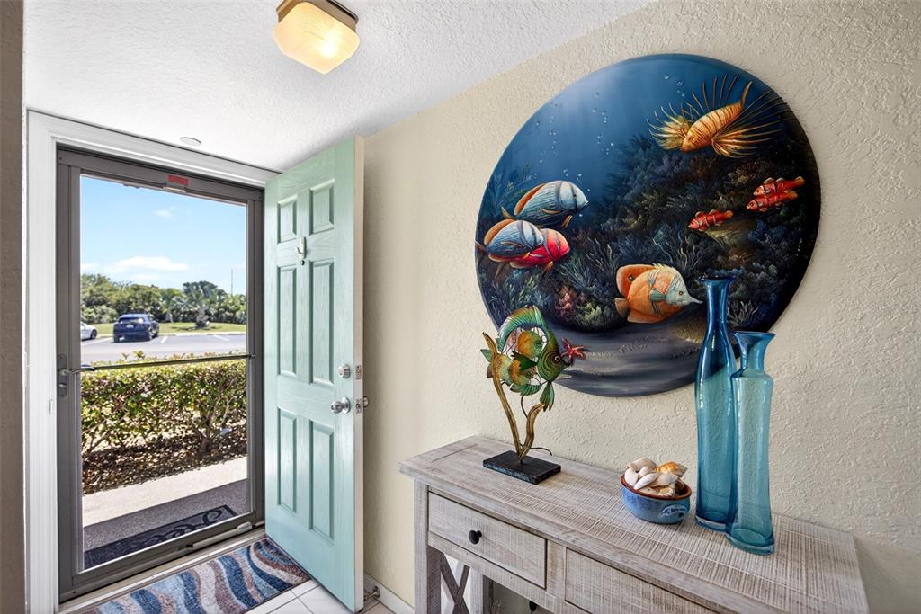 175 Kings Highway, Unit 516 Punta Gorda, FL 33983 - Photo 4 of 37 a table with wine and a potted plant