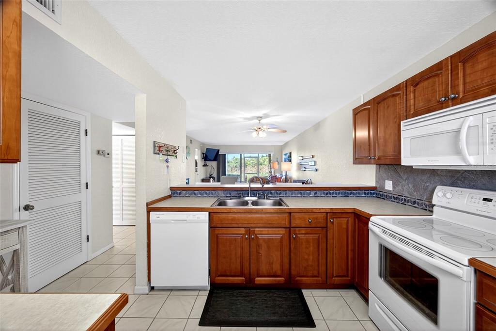 175 Kings Highway, Unit 516 Punta Gorda, FL 33983 - Photo 6 of 37 a kitchen with a stove sink and cabinets