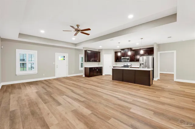 a view of kitchen with sink microwave and cabinets