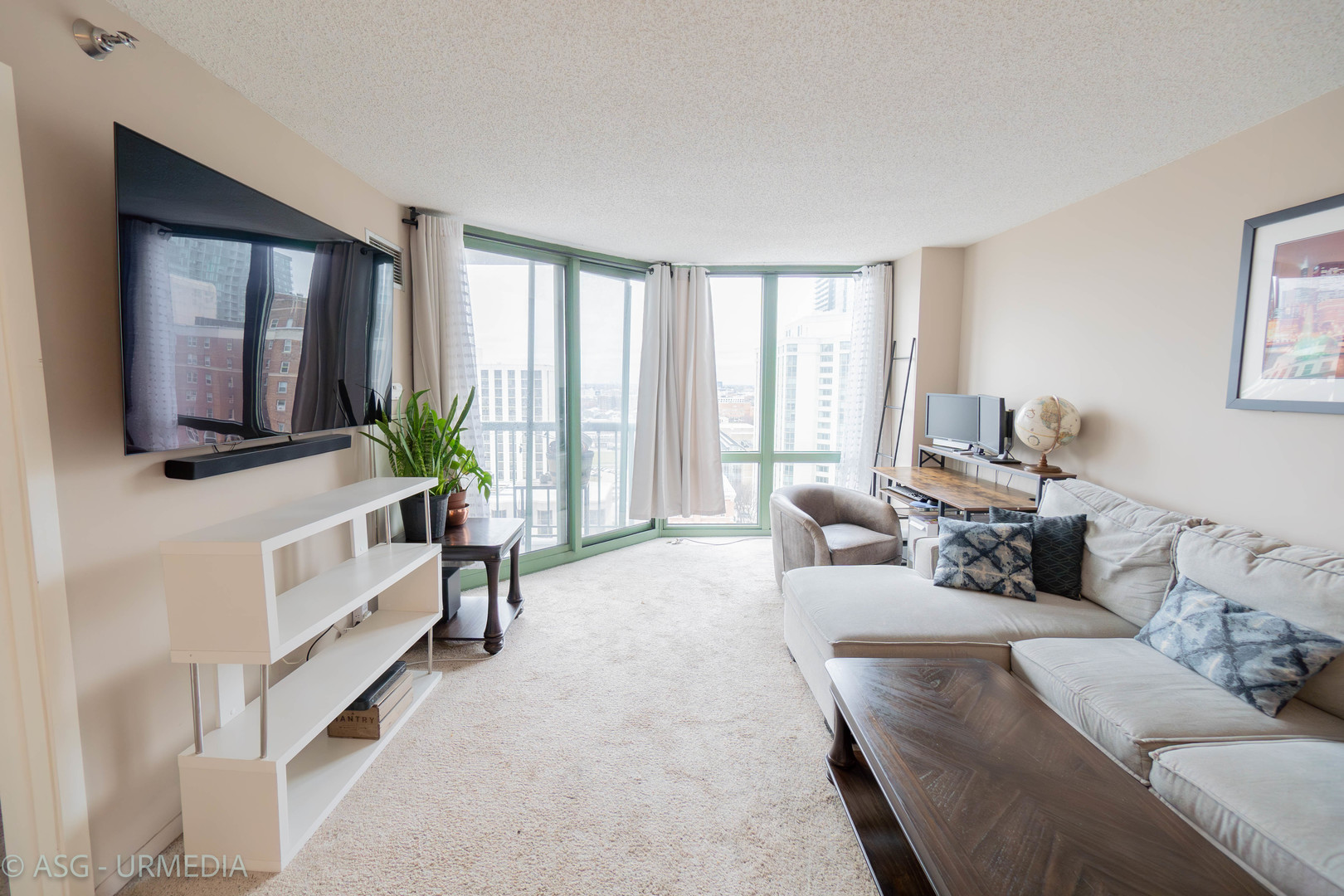 111 West Maple Street, Unit 1211 Chicago, IL 60610 - Photo 3 of 14 a living room with furniture and a flat screen tv