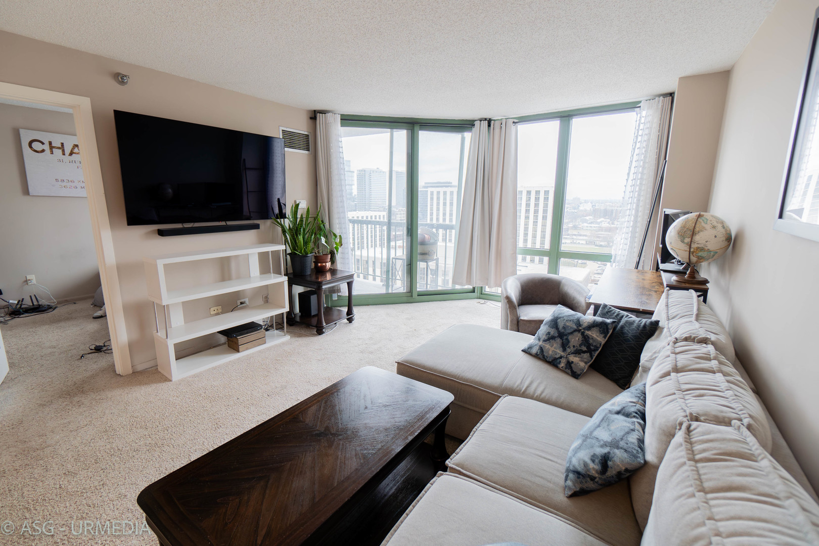 111 West Maple Street, Unit 1211 Chicago, IL 60610 - Photo 4 of 14 a living room with furniture and a flat screen tv
