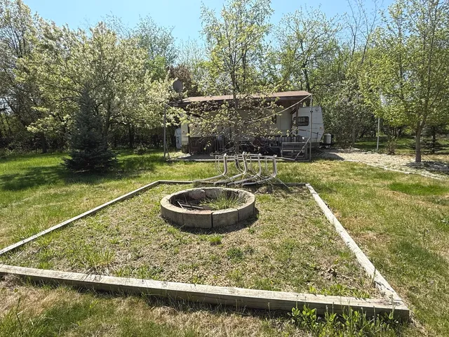 a view of a swimming pool with a patio and a yard