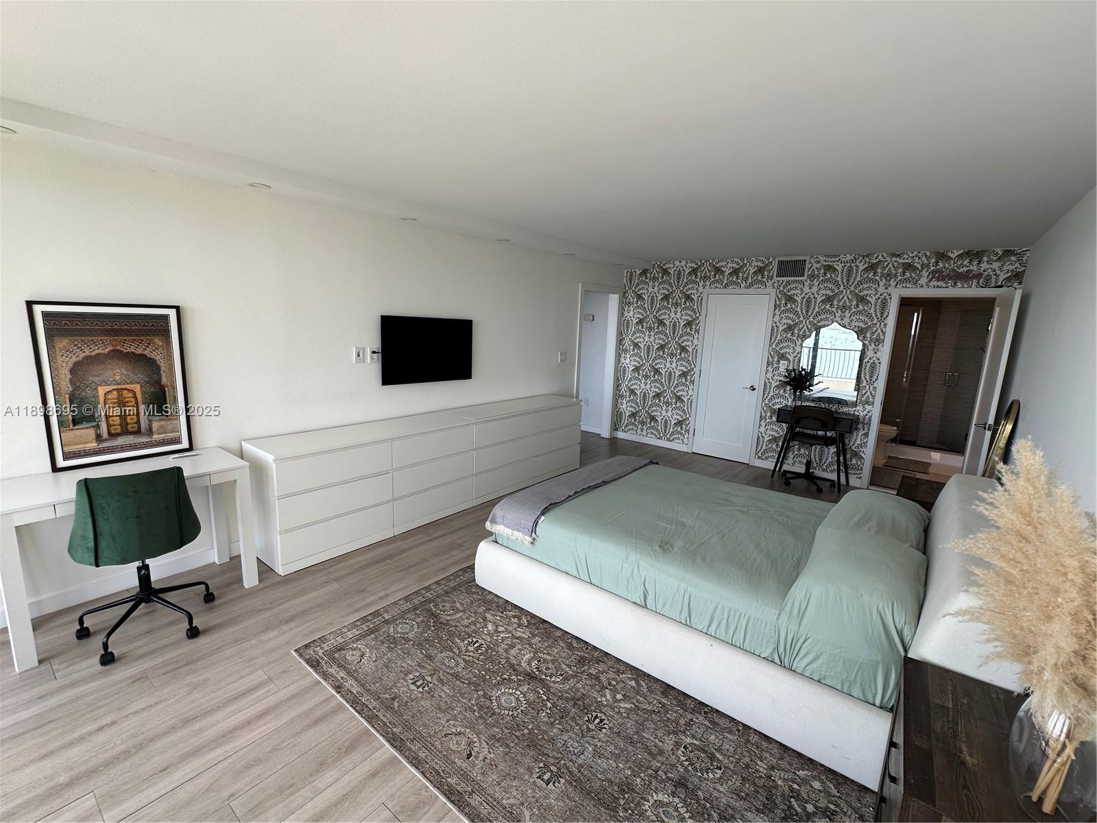 555 Northeast 15th Street, Unit 23B Miami, FL 33132 - Photo 11 of 32 a living room with furniture and a flat screen tv